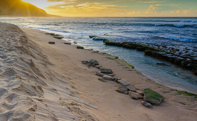 Waves Washing Over Exposed Coral Reef on the Shoreline of Kaena Point State Park at Sunset ,Oahu, Hawaii, USA