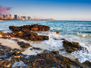 Sunset on The Shore at Sand Island Beach With The Honolulu and Waikiki Skyline, Sand Island State Recreation Area, Honolulu, Oahu, Hawaii, USA