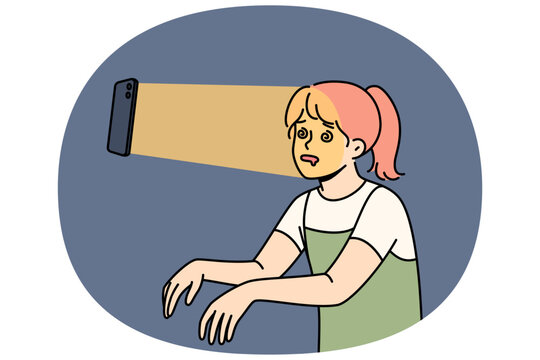 Teenage girl suffers from social media addiction following mobile phone in zombie pose. Problem children digital addiction forcing teenagers to waste time using smartphones and internet applications