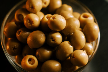 Olive variety in a glass bowl showcasing rich color and texture during evening light