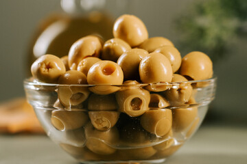 Olive bowl filled with fresh green olives on a kitchen counter