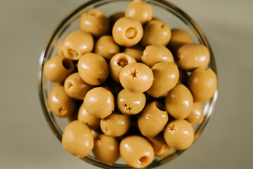Fresh green olives in a clear glass bowl ready for snacking or cooking