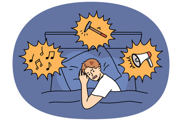 Noisy neighbors disturb sleep of irritated man lying in bed at night and in need of sleeping pills. Problem noisy neighbors causes insomnia for guy hearing sounds of music or using hammer for repairs