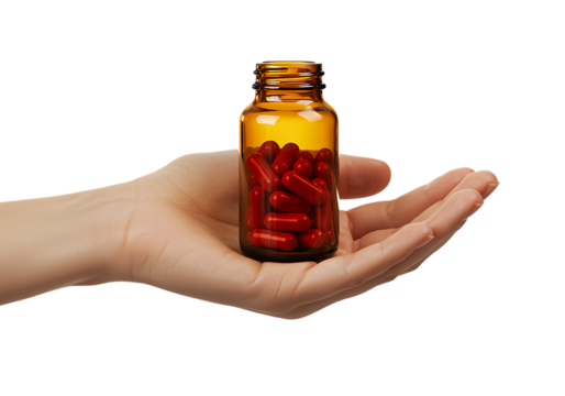 hand holding amber bottle with red capsules on transparent background