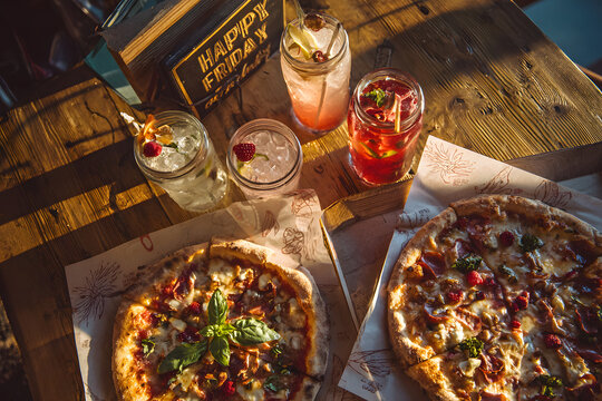 Happy Friday Pizza and Drinks Celebration on Table