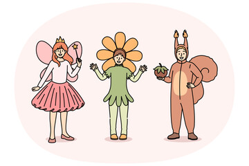 Little children in carnival costumes of squirrel or fairy and flower are ready to go to masquerade party at school. Boy and girls gathered for masquerade dedicated to end of studies in kindergarten