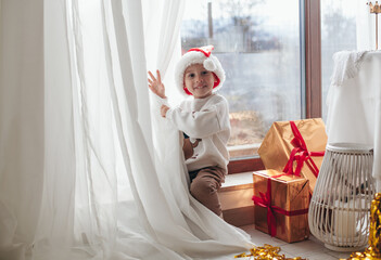 A boy plays near a window in Christmas