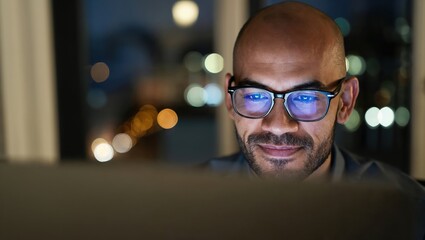 Man working late into the night from home using a laptop.