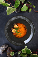 French bouillabaisse fish soup. Mussels, tiger prawns and spicy broth in soup. Photos for restaurant menu. Hot soup. Flat lay. Top view.