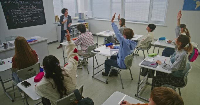 Female Teacher in Programming Class Calls Student to Blackboard to Correct Elements of Code. Learning Coding in Modern Classroom. Concept of Digital Education, Skills Development, Modern Education.