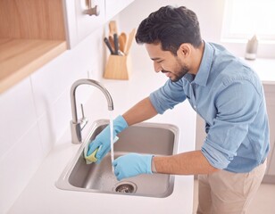 Daily Cleaning in a Modern Kitchen: A person meticulously cleans a kitchen sink, embodying the essence of hygiene and cleanliness. This image captures the importance of everyday household tasks.