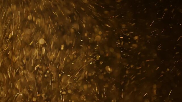 Soft pollen and dust  particles floating in the air, illuminated by warm light beams, creating dreamy abstract bokeh on a dark background. 4K macro footage with gentle motion and selective focus.