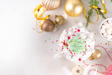 Festive tasty Christmas hot chocolate with whipped cream, marshmallows, sugar sprinkles and Christmas symbol decorations - marshmallow  Christmas tree, on festive holiday decorated  background