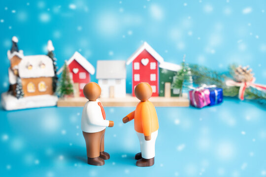 Two businessmen chat against the backdrop of a Christmas festive city. Business meeting, holiday discussion, festive networking, winter partnership, city conversation or christmas business concept