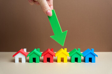 Woman chooses a house by pointing at it with an arrow. The best choice of housing. Competition winner. Choosing a home to buy. Realtor service. Affordable apartments choice. A row of colorful houses