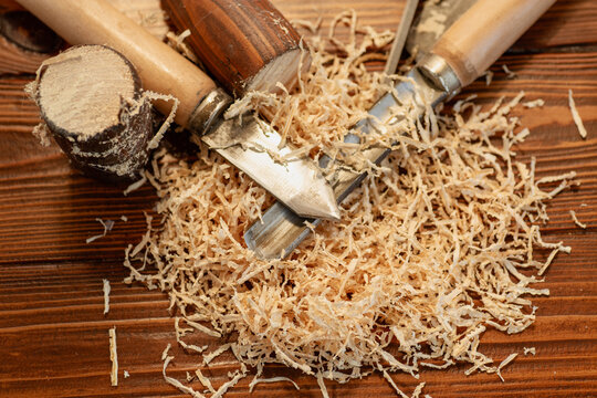 Close up of wood carving with sawdust on wooden table