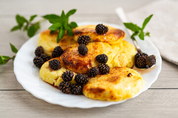 Traditional cottage cheese pancakes topped with pine cone syrup