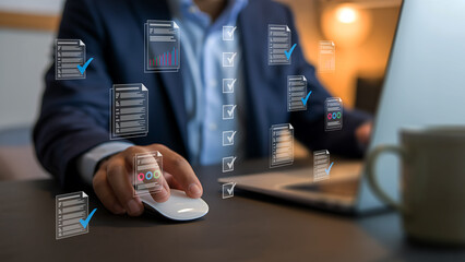 Businessman uses computer mouse with holographic data overlays