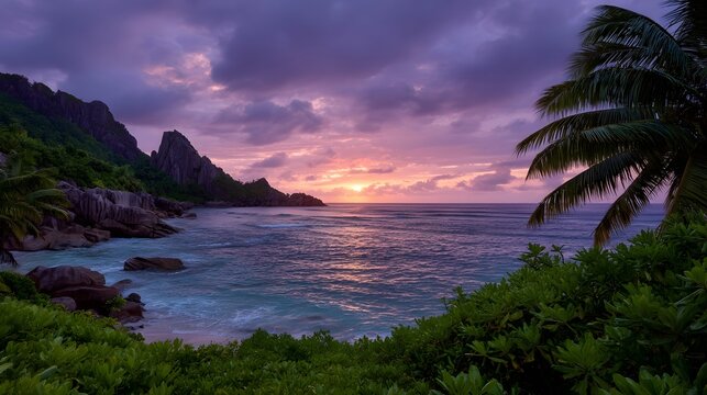 Tropical coastline at dusk with dramatic purple and pink sunset over the ocean