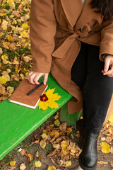 Woman puts pen on brown cover notebook	