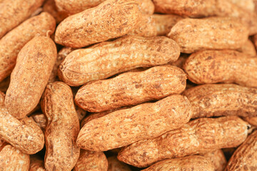 Fresh Unshelled Peanuts with Red Skins - Raw Groundnuts Background Texture