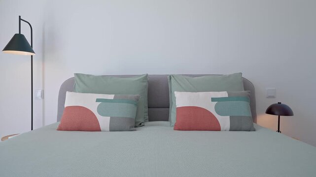 Minimalist bedroom gradually emerging, featuring clean lines, double bed with crisp bedding, complementary lamps, and neatly folded towels, embodying contemporary interior design elegance