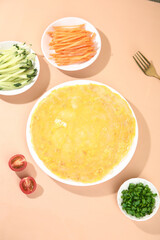 Healthy Buckwheat Burrito Ingredients with Fresh Vegetables and Roughage on Peach Background