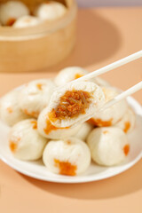 Traditional Xiaolongbao Chinese Soup Dumplings with Sweet Filling and Chopsticks