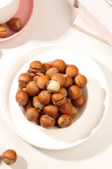 Handpeeled Hazelnuts with Shelled Kernels in White Bowl - Fresh Northeastern Nuts for Cooking and Healthy Snacking