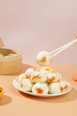 Traditional Xiaolongbao Soup Dumplings with Chopsticks and Bamboo Steamer Basket