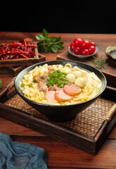 Handrolled Fat Beef Noodle Soup with Wide Pasta and Sausage in Cast Iron Pan on Wooden Table