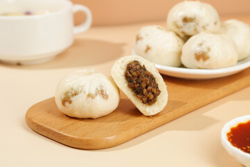 Traditional Chinese Xiaolongbao Steamed Buns with Pork Filling and Tea