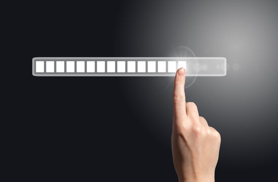 Futuristic concept of progress and innovation with a hand touching a digital loading bar. Symbol of