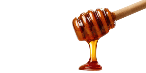 Thick golden liquid dripping from a wooden dipper