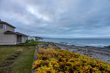 A serene early morning view at the St. Lawrence River in Baie-des-Sables, Quebec, capturing the tranquil beauty of the shoreline.