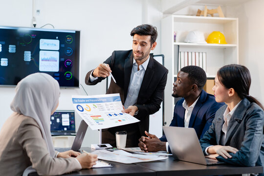 team of multiethnic colleague discuss budget performance planning, sharing idea for cost reduction, business people man woman diverse employee coworker in formal suit meeting in finance office
