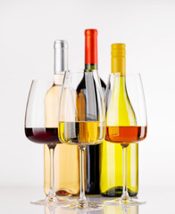 Naklejka premium Different wine bottles and glasses on white background