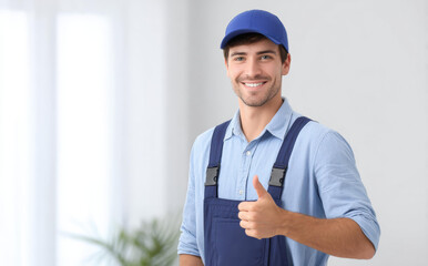 Happy professional worker, young male technician in blue uniform, smiling with thumbs up. Quality repair and maintenance service for home or office installation