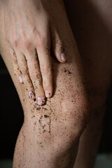 Fototapeta premium Coffee body scrub on female legs