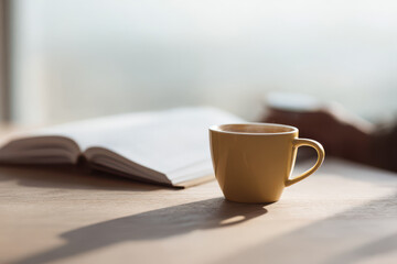 steaming cup of coffee sits on wooden table next to open notebook and blurred white text bars interface