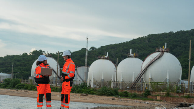 Energy professionals plan sustainable operations at a coastal gas terminal. The team uses technology to monitor environmental impact and ensure safe fuel storage.
