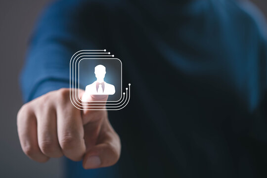 Close-up of a hand touching a virtual icon of a businessperson, symbolizing digital connection, leadership, HR technology, and innovation in modern business and networking concepts.