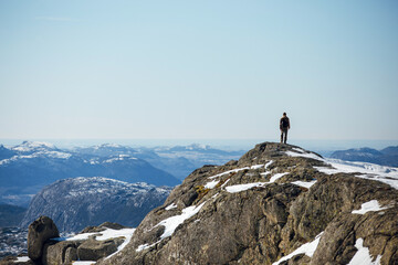 Lone Hiker on Snowy Mountain Peak