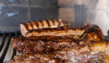 Juicy argentine barbecue meat grilling on a charcoal parrillada, preparing delicious cuts of beef and chorizo for a traditional outdoor meal, fresh food cooking
