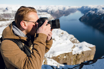 Photographer Capturing Snowy Mountain Fjord
