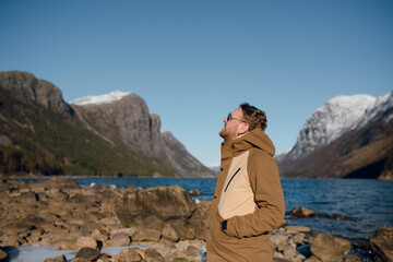 Man Enjoying Scenic Mountain Lakeside View