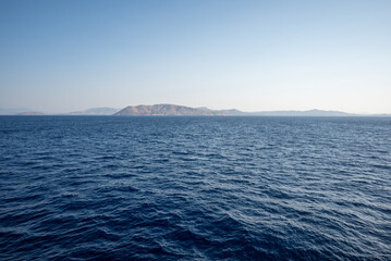 Fototapeta premium Tranquil Sea with Distant Island