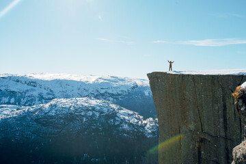 Triumphant Pose on Snowy Cliff Edge