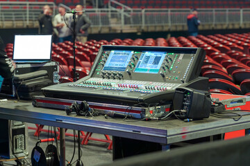 Sound and lighting engineers equipment set up in a concert venue before the show, ready for managing audio and visual effects during the performance