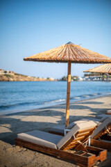 Beachside Relaxation with Straw Umbrellas
